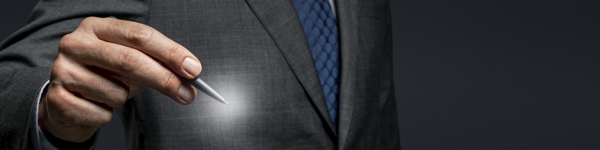 Businessman using a pen and signing on an invisible screen